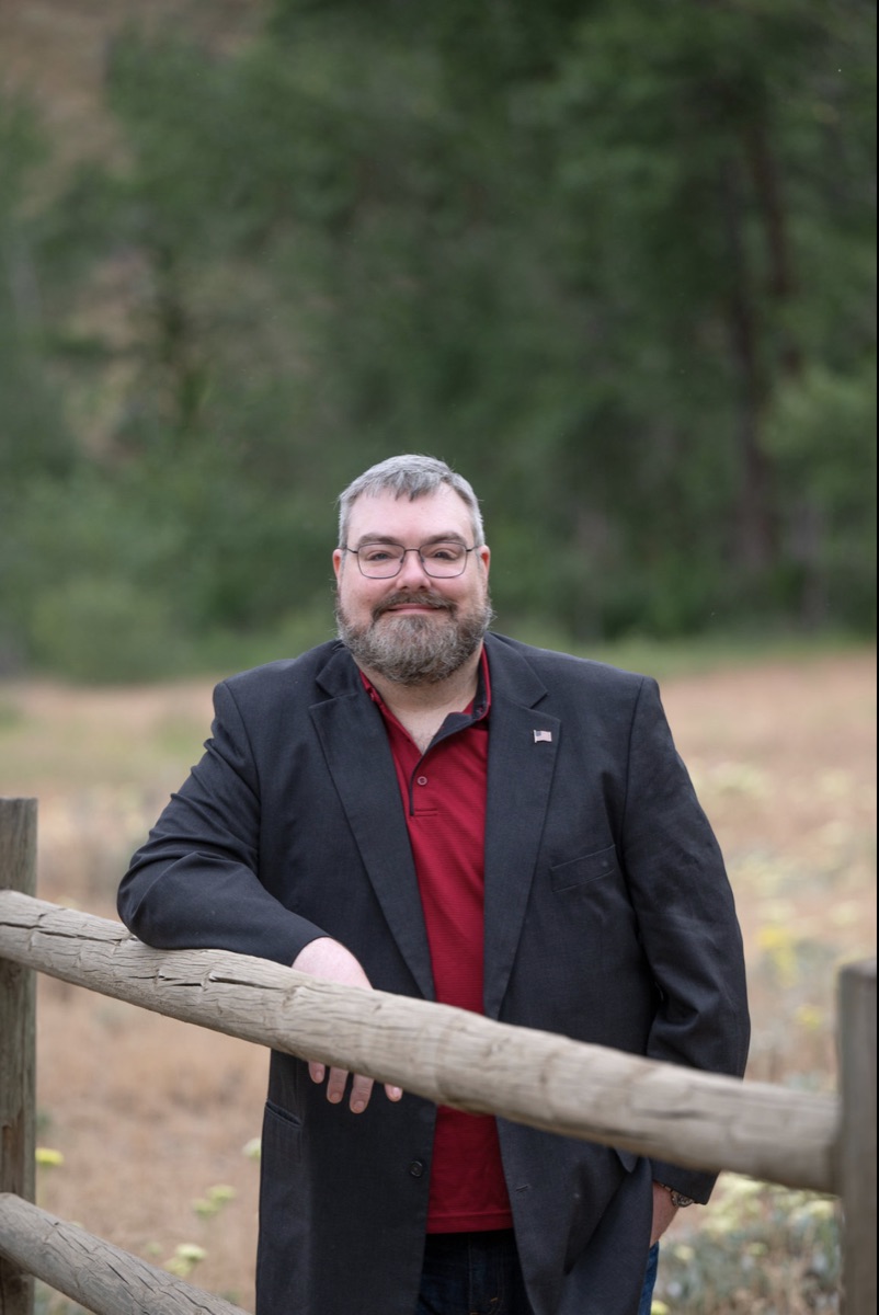 Joshua Thompson at a split-rail fence in Central Washington